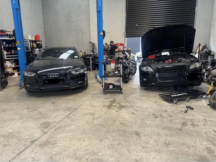 Two vehicles being worked on in the workshop
